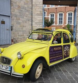 a yellow car with two people sitting in it