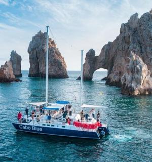 a boat in the water near a rock formation