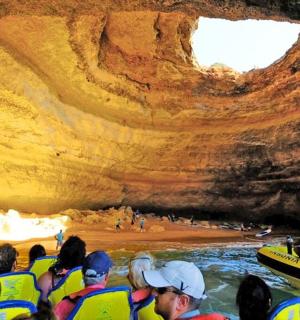 a group of people in a raft in a cave