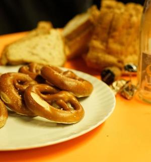 a plate of pretzels and bread on a table