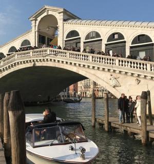 a boat is docked in front of a bridge