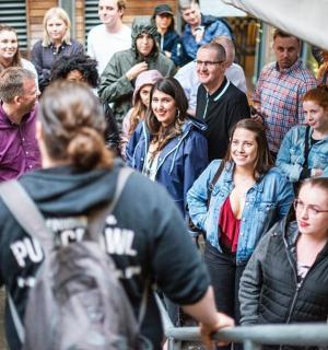 a crowd of people walking down a street