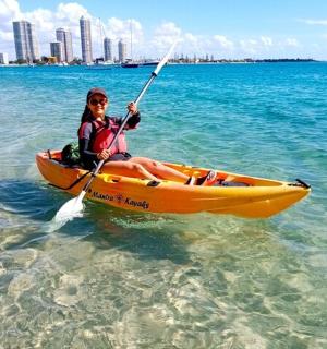 a woman is sitting in a kayak in the water