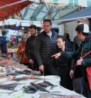 一群人在市场上看鱼