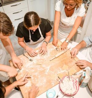 a group of people standing around a table working