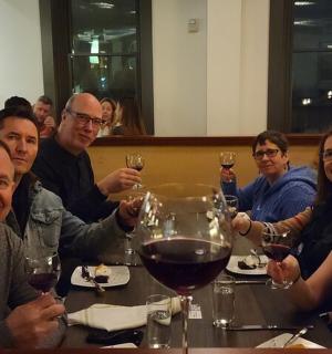 a group of people sitting at a table with wine glasses
