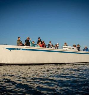 a group of people on a boat in the water
