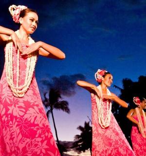 three women in pink dresses are standing together