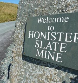 a sign on the side of a rock