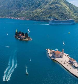 an island in a large body of water with boats