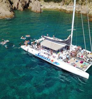 a group of people on a sail boat in the water