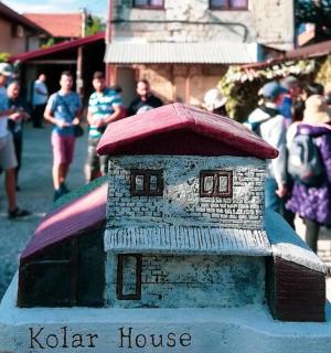 a model of a house with a crowd of people