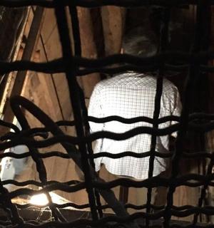 a man is standing behind a mesh net