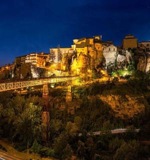 a view of a city with a bridge at night