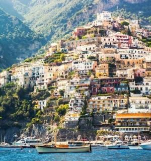 a town on a hill with boats in the water