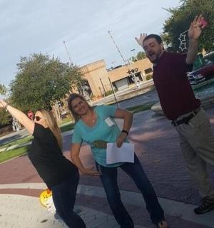 a group of three people posing for a picture