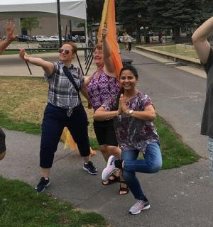 a group of people standing on a sidewalk with their hands up