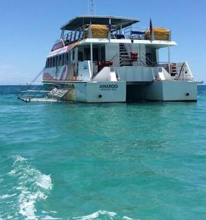 a boat sitting in the middle of the ocean