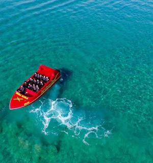 a red boat in the middle of the water