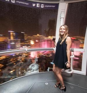 a woman standing on top of a skyscraper