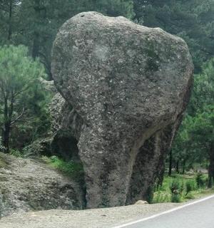 a large rock on the side of a road