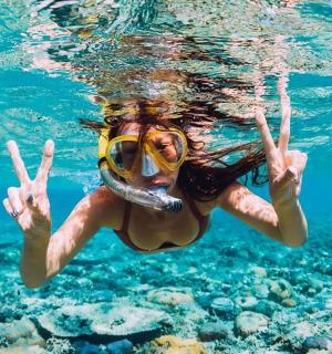 a woman in the water wearing a snorkel