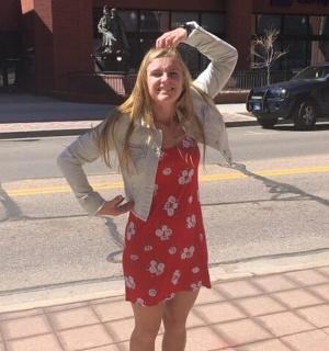 a woman in a red dress standing on a street