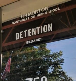 a sign on the window of a departmentuationuation high school