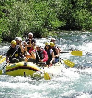 a group of people in a raft in a river