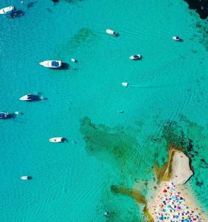 an aerial view of a group of boats in the water