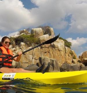 a woman in a yellow kayak in the water