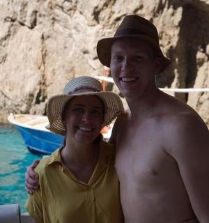 a man and a woman standing on a boat in the water