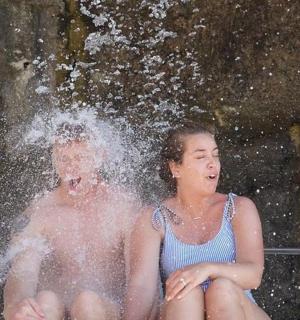 a man and a woman sitting in a fountain