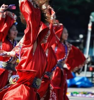 two women in red costumes performing a dance