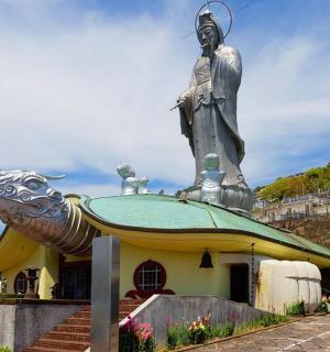 a statue of a woman on top of a building