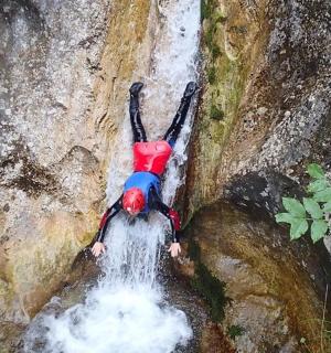 a person laying on top of a waterfall