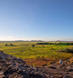 a person standing on top of a rocky hill