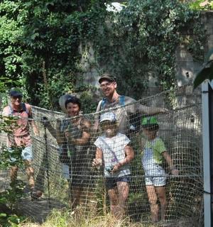 a group of people standing behind a fence