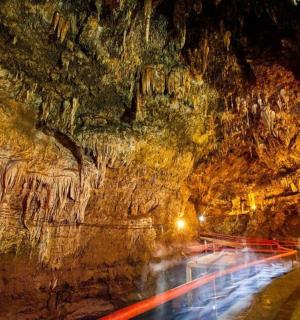 a road in a cave at night with lights