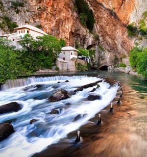 a river with rocks in the middle of a waterfall