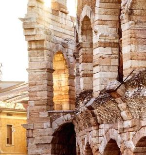 an old stone building with an archway on it