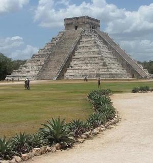 a pyramid with people standing in front of it