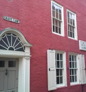 a red building with a white door and windows