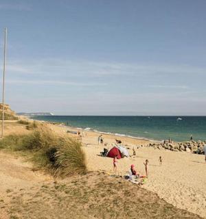 a group of people on a beach near the ocean