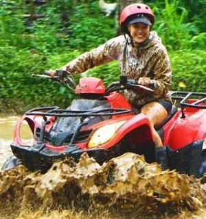 a woman riding a dirt bike through the mud