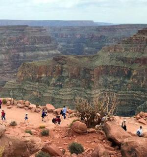 a group of people walking around the grand canyon