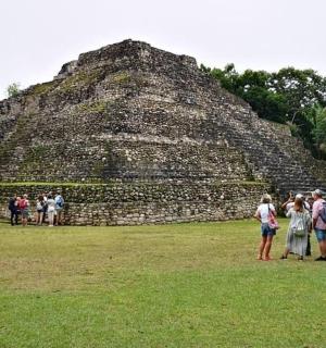 a group of people standing in front of a pyramid