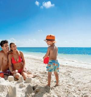 a group of three people sitting on a beach