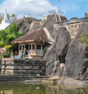 a small building on the side of a rock formation