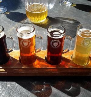 a tray of different types of beers on a table